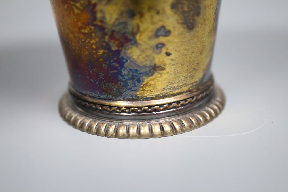 A George V silver gilt beaker, of flared form, Vander & Hedges, London 1912, 11.3cm, 6oz.